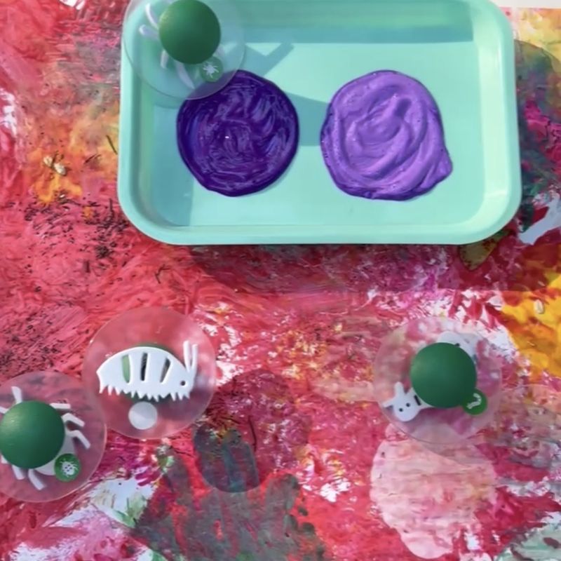 Bug stampers and purple paint on the class canvas